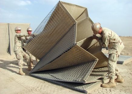 090411-N-8547M-025 HELMAND PROVINCE, Afghanistan (April 11, 2009) Seabees assigned to Naval Mobile Construction Battalion (NMCB) 5 lift a HESCO barrier into alignment during a project at Camp Bastion. NMCB-5 is deployed to Afghanistan providing contingency construction support to allies and members of the NATO International Security Assistance Force (ISAF). NMCB-5 is one of the Naval Expeditionary Combat Command warfighting support elements providing host nation contingency construction support and security. (U.S. Navy Photo by Mass Communication Specialist 2nd Class Patrick W. Mullen III/Released)